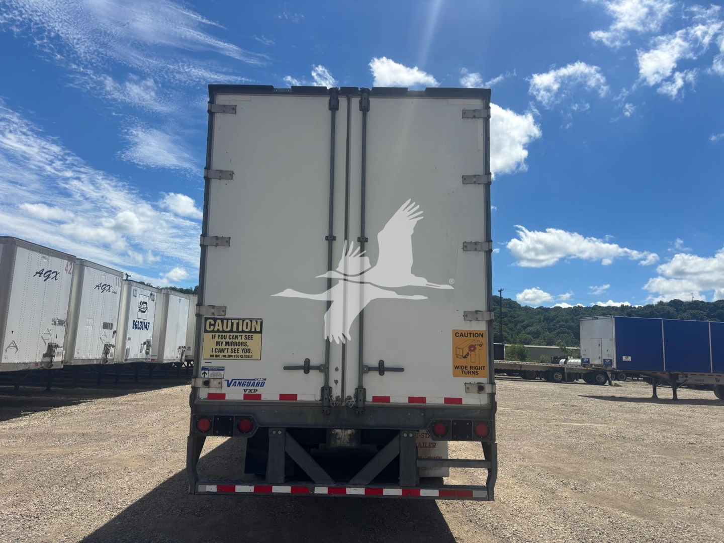 Rear view of a Vanguard VXP trailer showing double rear doors with warning stickers and taillights.