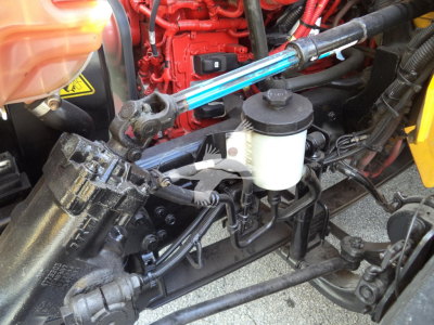 Truck engine bay showing hydraulic reservoir and components
