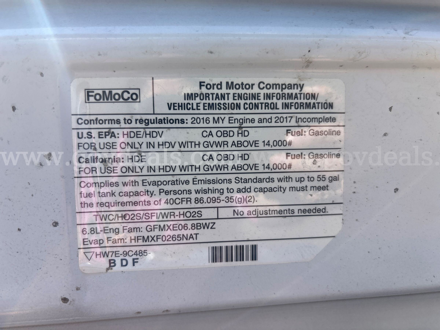 Ford motor company label on driver door jamb with engine information and fuel specifications.