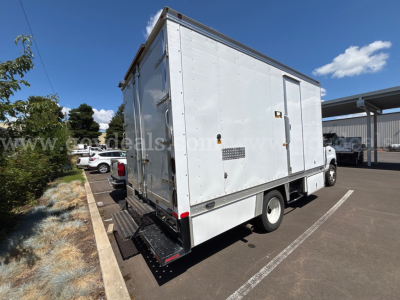 Box truck rear view showing cargo box and rear entry doors on a white 2017 Ford Econoline with side ventilation and steps.