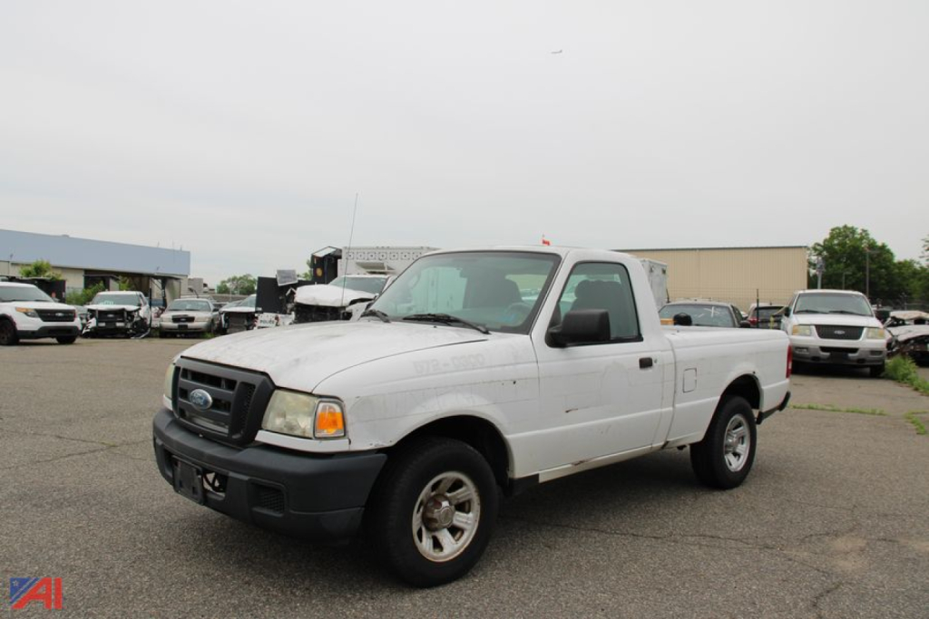 Ford Ranger pickup truck in a used lot, white extended cab 2006 model, two-door, 2WD with black front bumper and wheels. No visible text on vehicle signs.