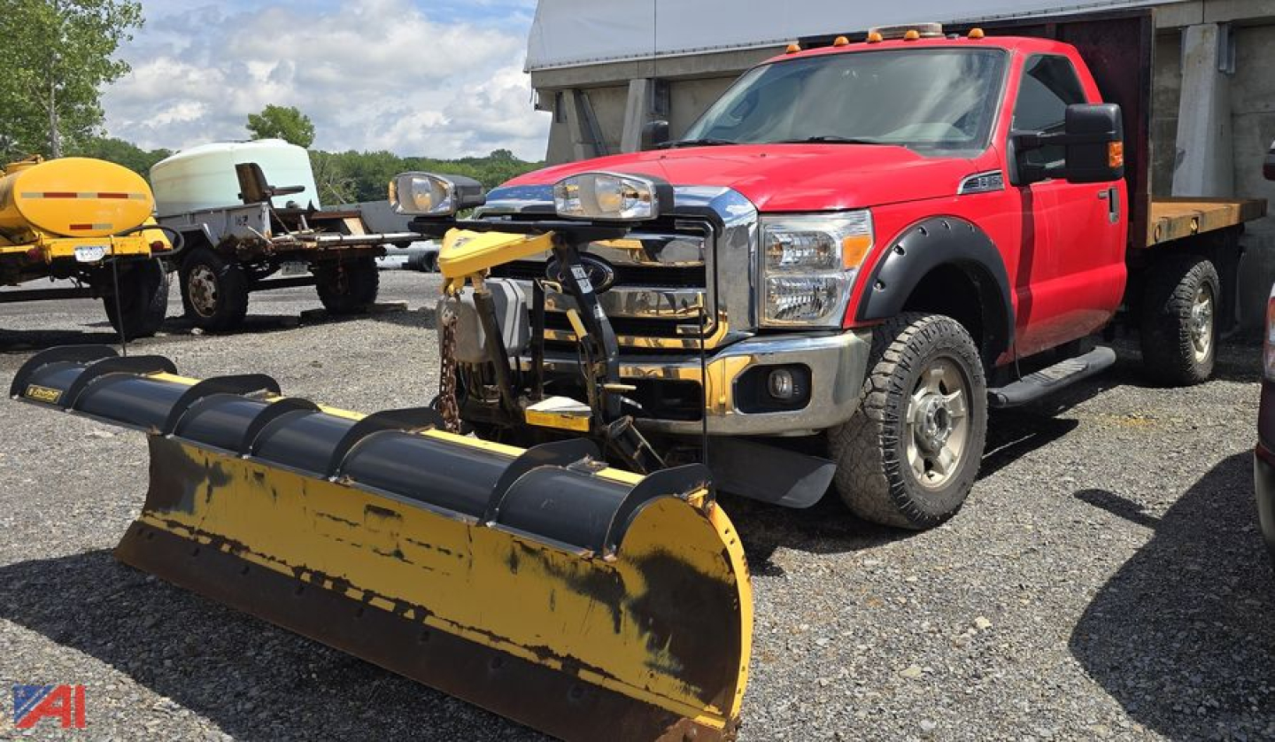 Red 2016 Ford F-250 Super Duty pickup with a front plow attachment and snowplow equipment in the foreground.