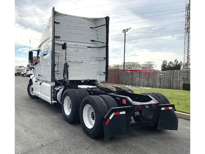 Truck chassis and sleeper cab of a 2022 Volvo VNL 760 tractor viewed from rear-left showing fifth wheel, rear dual axles, and surrounding area.