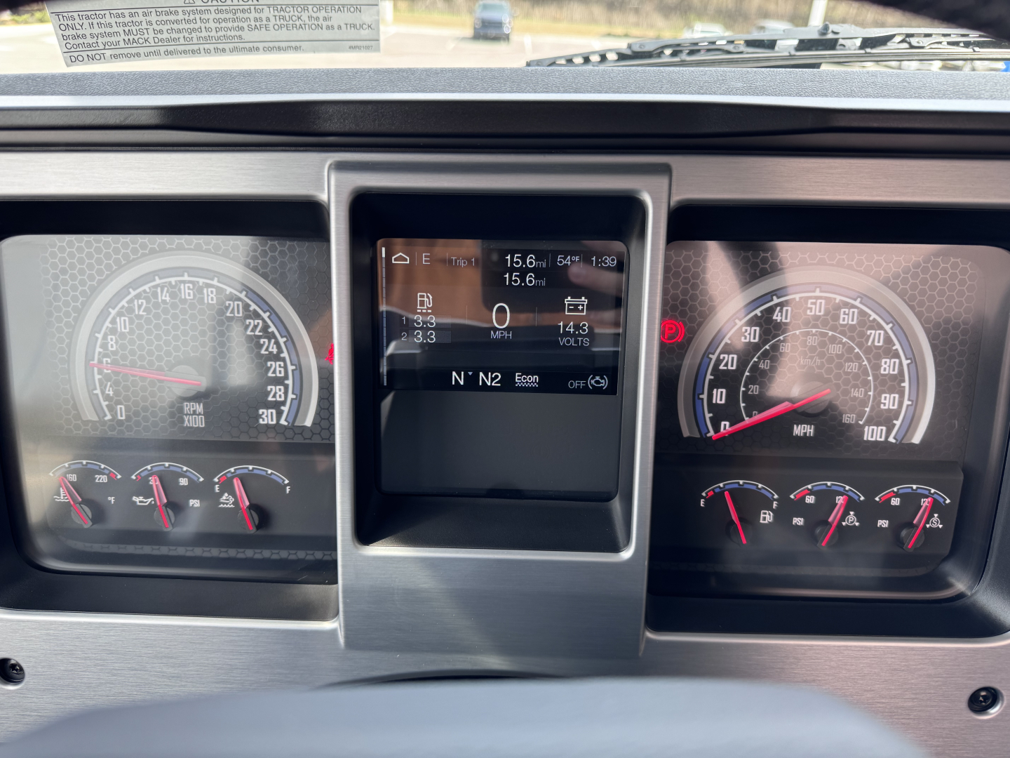 Mack PI64T cab dash showing instrument cluster and center digital display.
