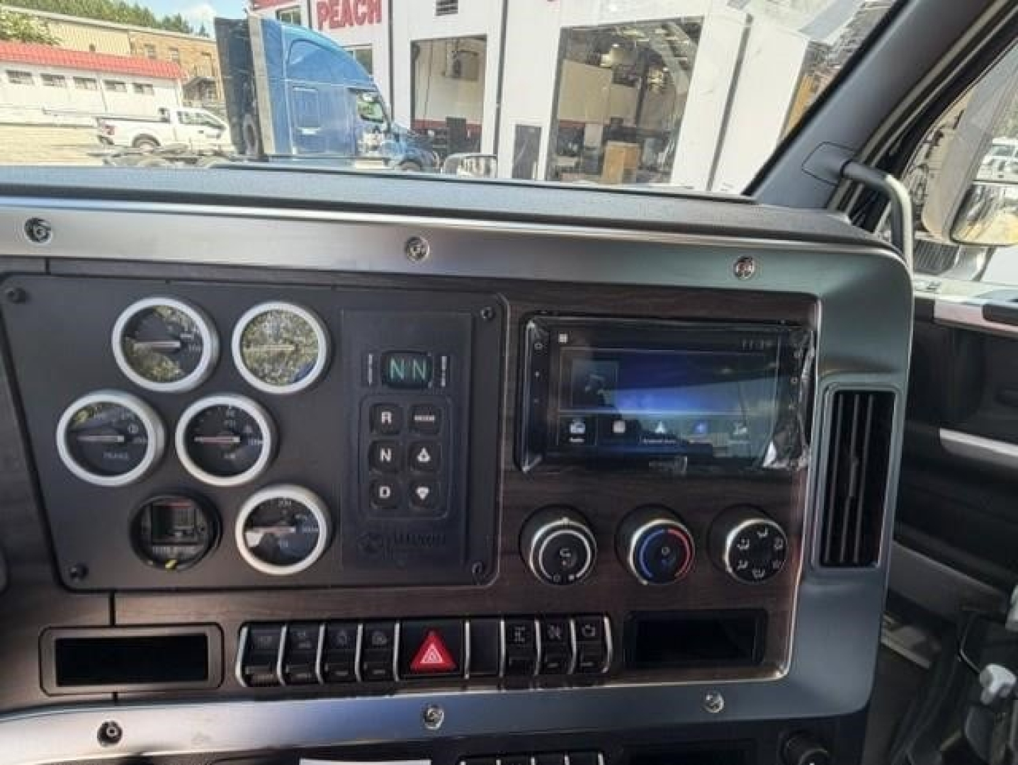 Dashboard view of a 2027 Western Star 47X showing instrument cluster, gauges, climate controls, and a touchscreen infotainment system.