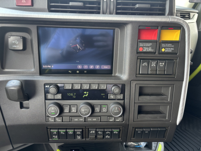 Dashboard of Volvo VNL64T860 cab interior showing touchscreen display, radio controls, climate controls, and various switches.
