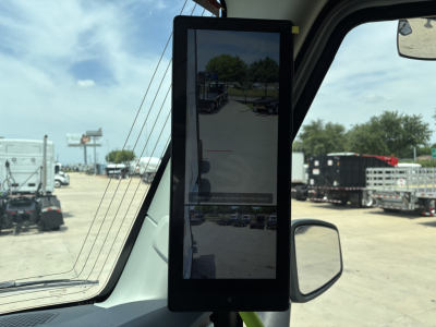 Volvo VNL64T860 truck interior view showing a tall tablet in the driver's door frame and side mirror.
