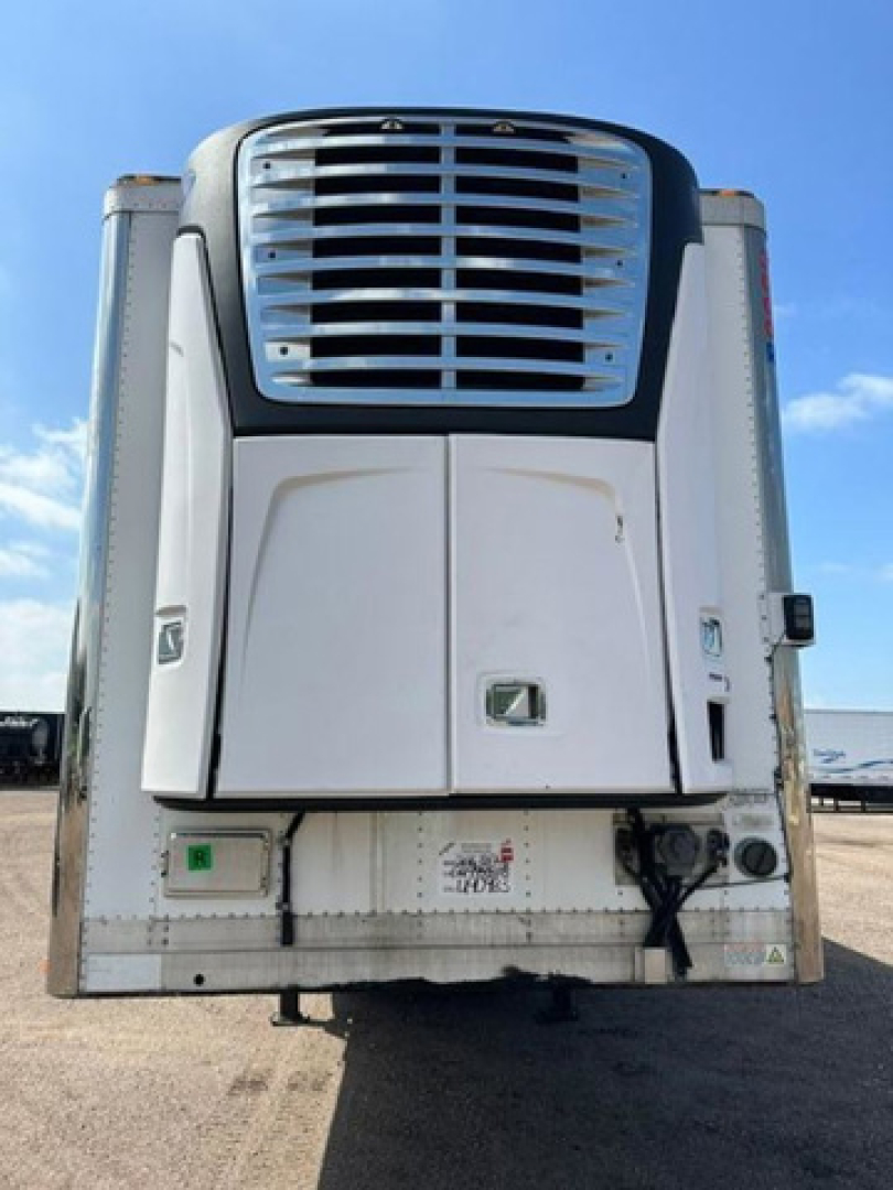 Front view of a 2016 utility refrigerated trailer showing the refrigeration unit on the front with a vertical grille and white body panels.