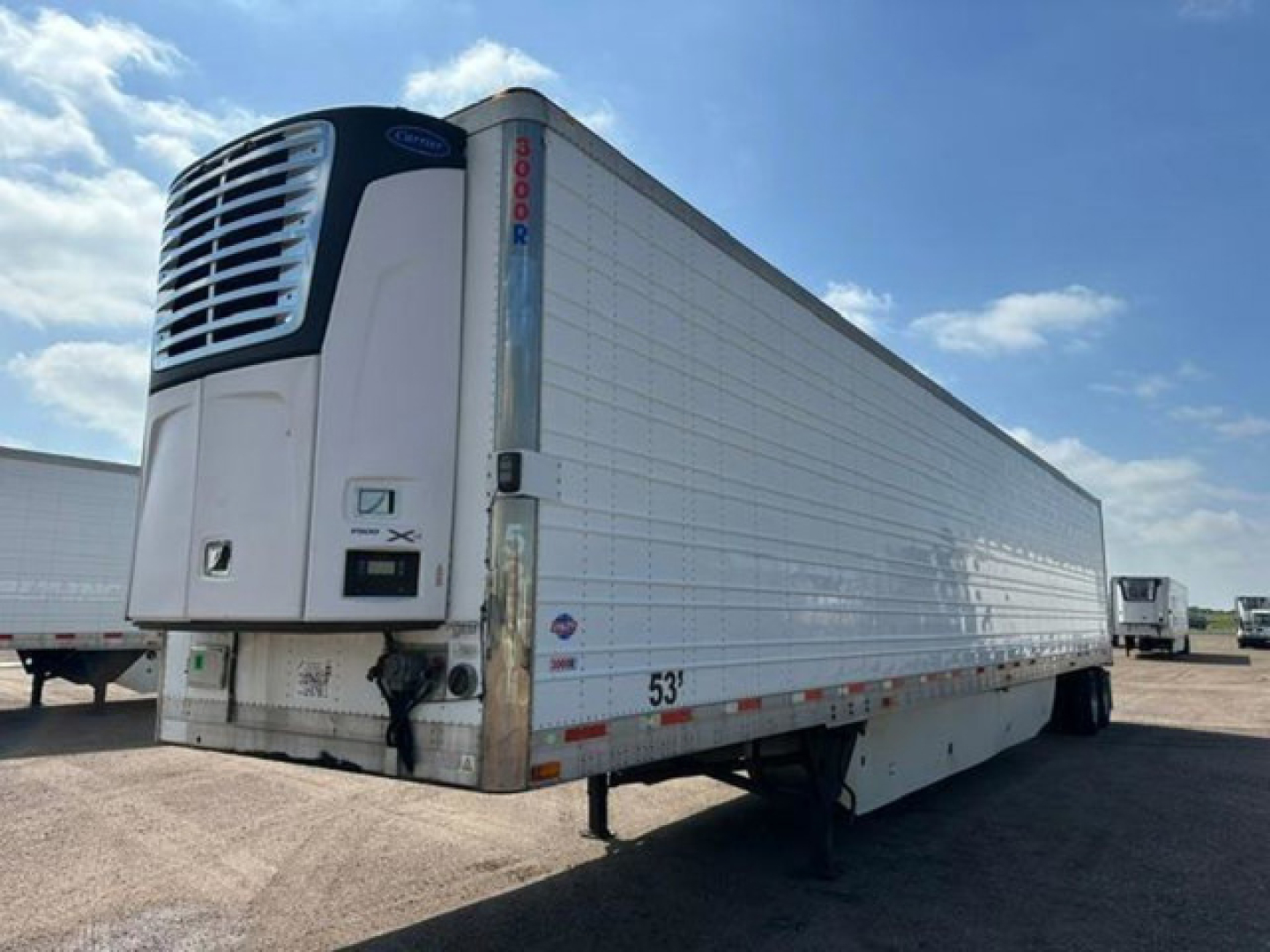 Reefer trailer showing front refrigeration unit and side profile with 53' length and I-beam structure, unknown refrigeration manufacturer label, overcast sky