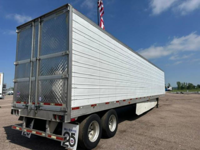 Trailer side view of a 2016 utility refrigerated trailer with closed aluminum panels and dual rear doors.