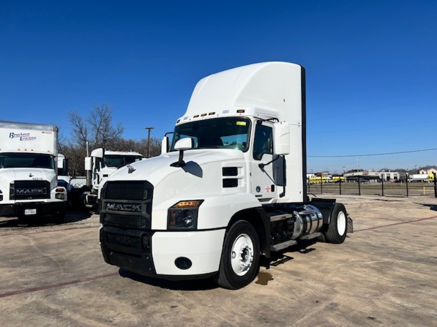Mack AN42T conventional daycab truck in white, side view showing cab, fuel tanks, and front grille.