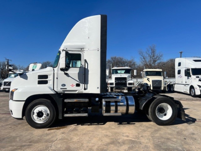 White 2022 Mack AN42T conventional daycab truck side view showing cab, fuel tanks, and chassis.