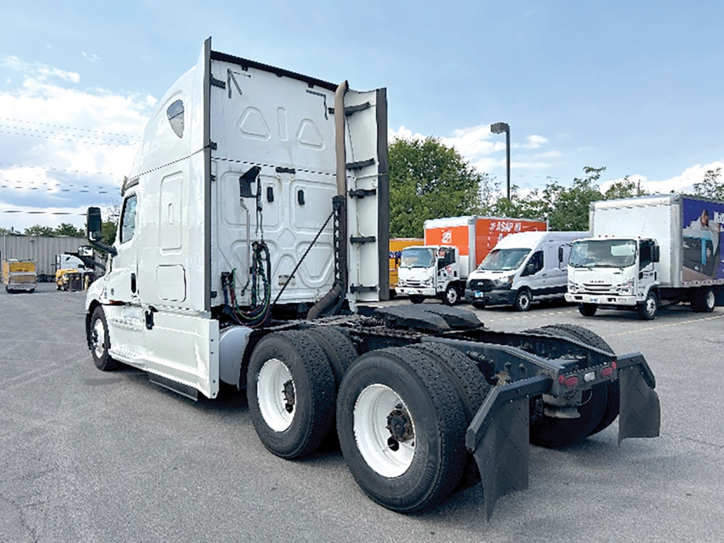 Freightliner Cascadia126 tractor-trailer rear and side view showing tandem axles and fifth-wheel area.