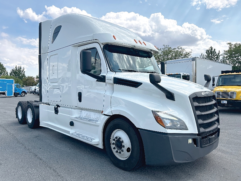 Freightliner Cascadia126 sleeper cab truck showing front and side view with white paint and black grille.