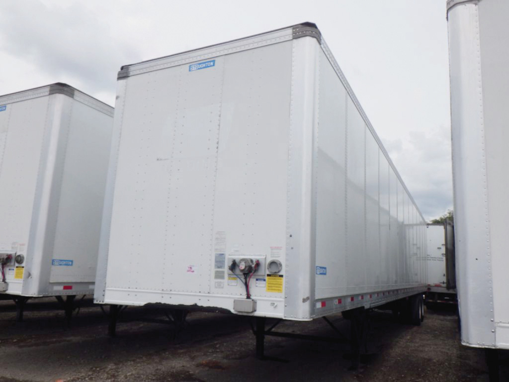 Trailer rear and side view of a 2022 Stoughton Z-Plate dry van trailer showing front and side panels with ventilation and safety decals.