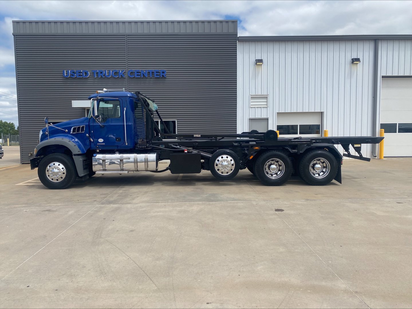 2019 Mack GR64F rolloff truck side view showing chassis and six-wheel arrangement