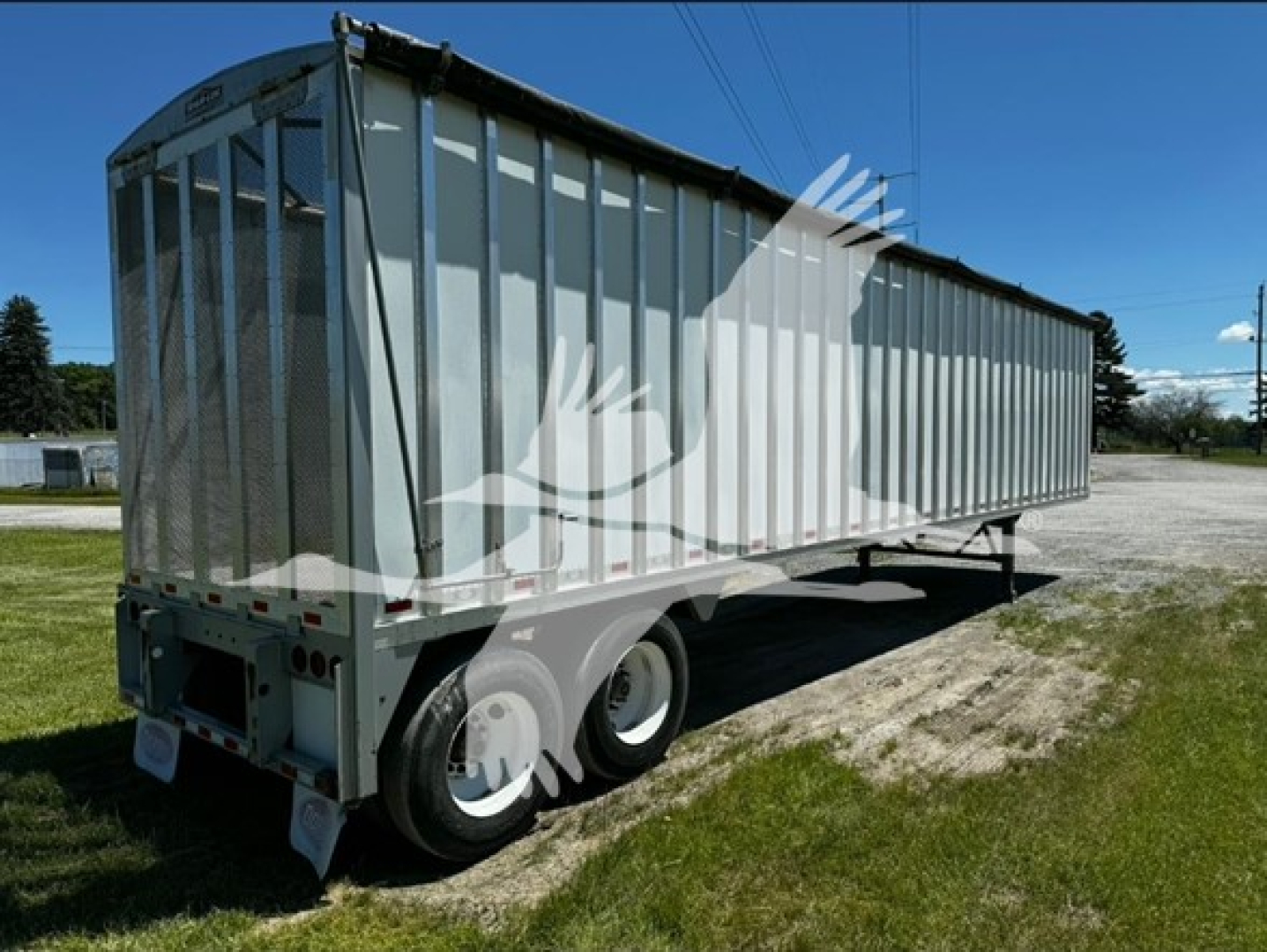 Trailer side view showing 2022 Dorsey open top chip van with high sidewalls and dual rear wheels.