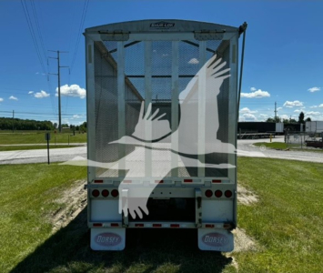 Back view of a 2022 Dorsey open top chip van trailer showing rear doors and taillights with Dorsey mud flaps.