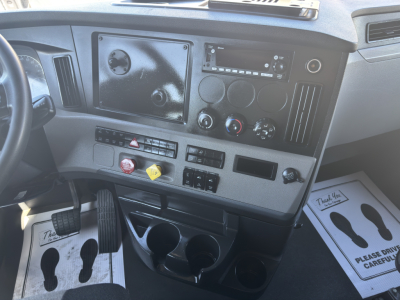 Freightliner Cascadia truck dash showing control panel and cup holders