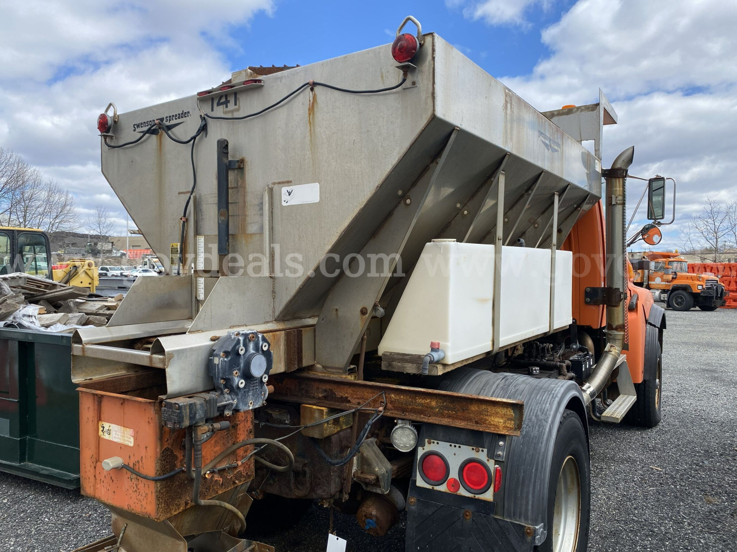 Dump truck chassis and dump bed of a 2005 Sterling L9500 with visible rear wheels, hydraulic components, and tailgate area.