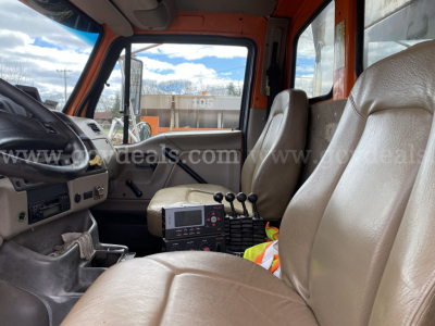 Cab interior of a 2005 Sterling L9500 dump truck showing driver and passenger seats, dashboard, gear shifter, and control console.
