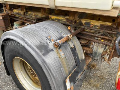 Sterling L9500 dump truck showing worn tire and rear undercarriage with rusted components and weathered paint.