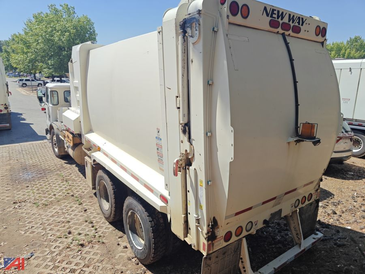 Autocar XPeditor Packer Truck rear and side view showing dump body and rear tailgate with 'NEW WAY' branding on top edge.