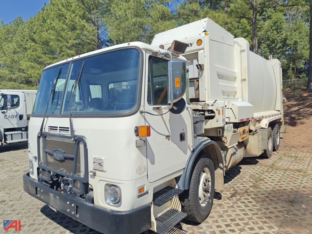 Autocar XPeditor Packer truck in-service front view showing cab and large rear waste compactor unit with white body and black bumper.