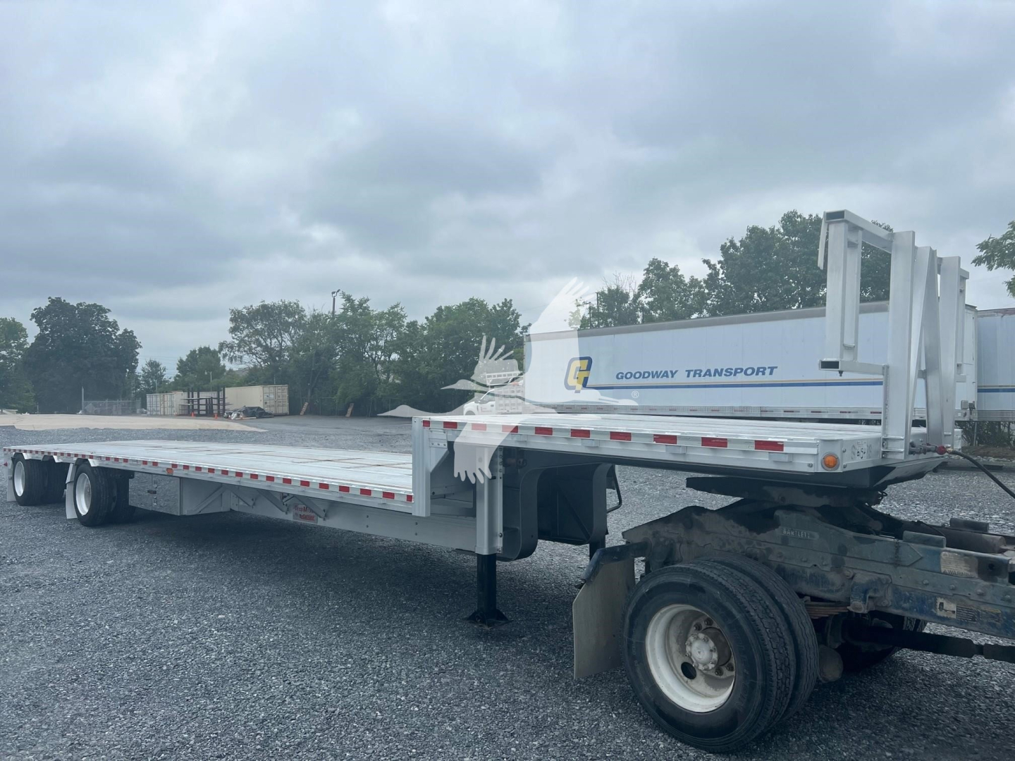 Trailer shows a 2018 Reitnouer Dropmiser flatbed with extended drop-deck and rear wheels. Side rails, front gooseneck area, and brand markings visible.