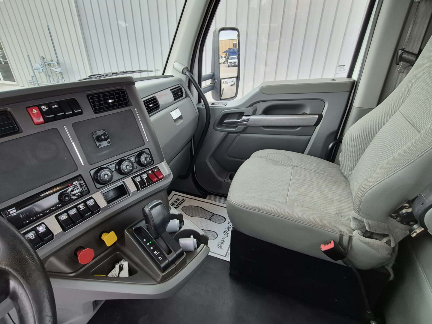 Kenworth T880 interior dash and driver seat showing center console and gear shifter