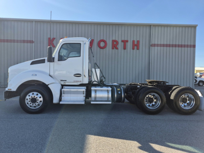 Kenworth T880 2018 conventional daycab tractor in white, side view with dual rear axles, fuel tanks, and wheel configuration visible.
