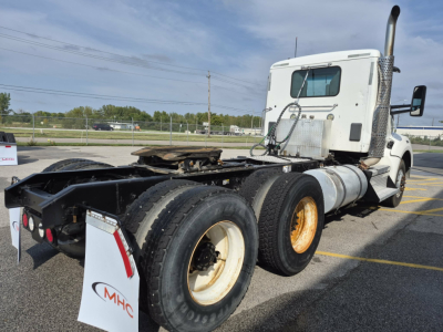 Kenworth T880 tractor with fifth wheel removed showing rear dual axle on highway lot.