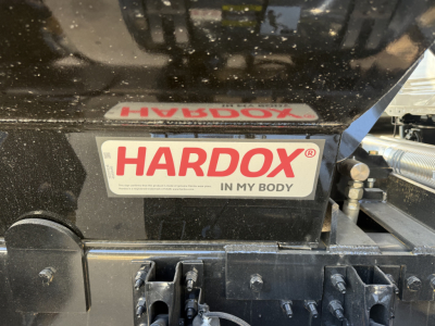 Mack PI64 truck engine bay showing HARDOX in my body sticker and surrounding metal components.