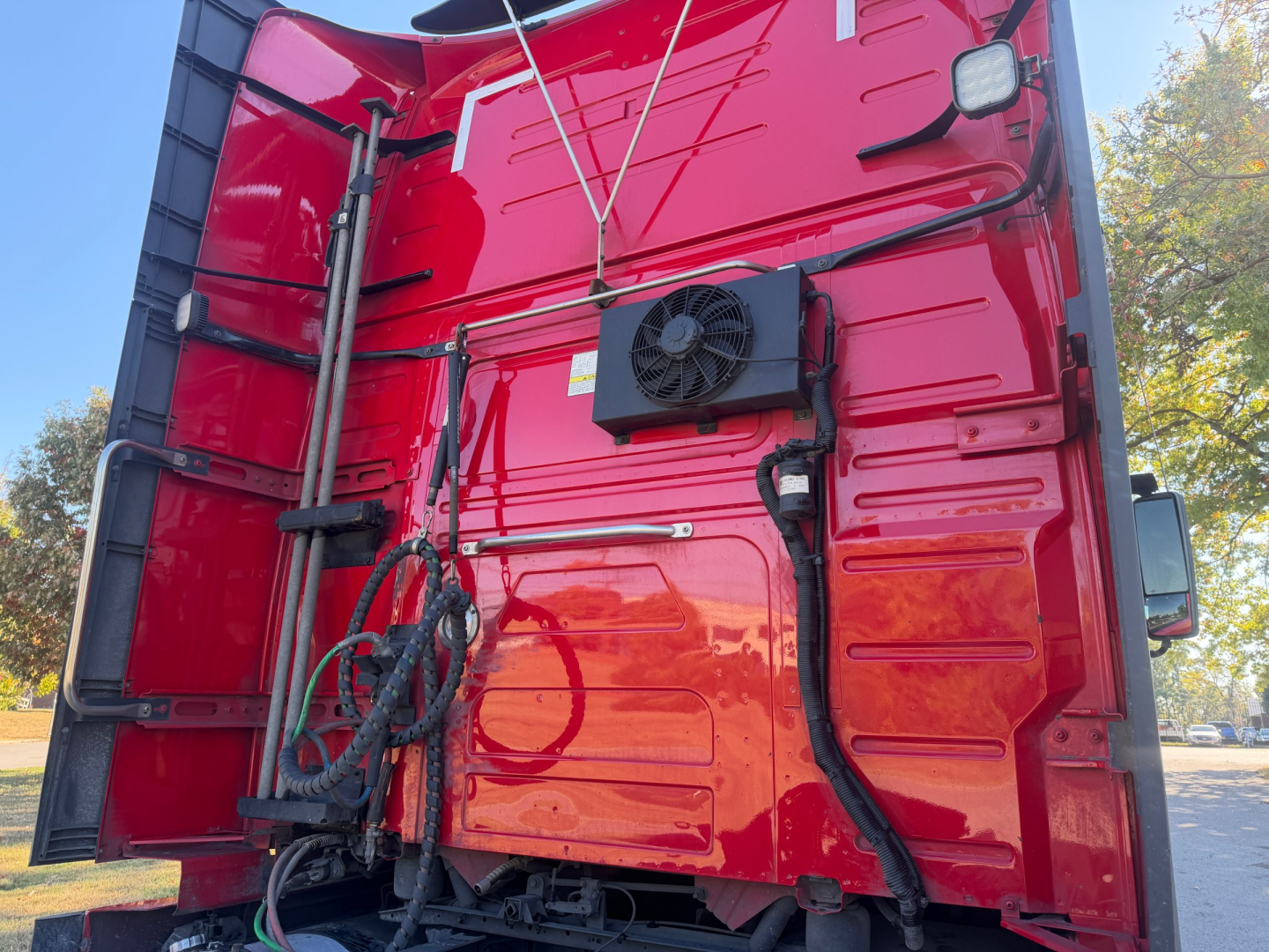 Volvo VNL64T760 cab interior rear view showing electrical harnesses and cooling fan mounted on red interior wall.