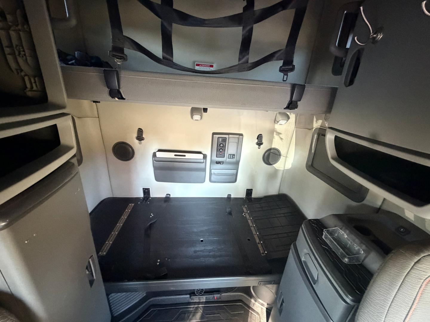 Volvo VNL64T760 sleeper cab interior view of cargo area with side panels and storage compartments.