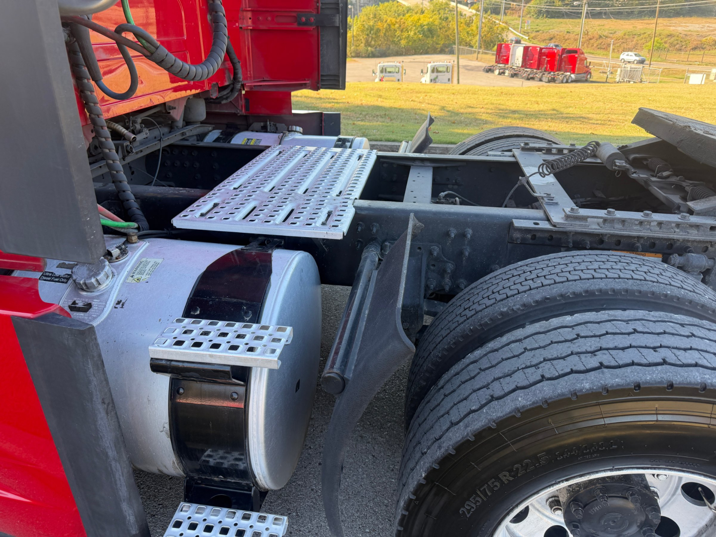 Volvo VNL64T760 truck chassis showing fuel tank, ladder steps, and rear dual tires in view.