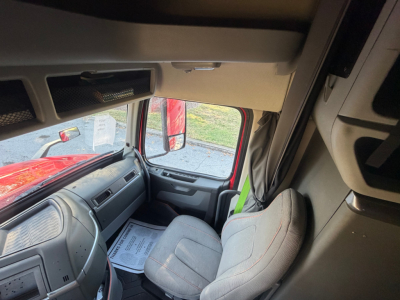Cab interior of a 2022 Volvo VNL64T760 tractor showing steering wheel, dashboard, and seating area