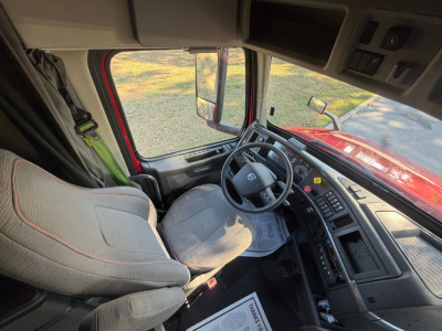 Volvo VNL64T760 truck cabin interior with steering wheel, driver seat, and dashboard controls visible.