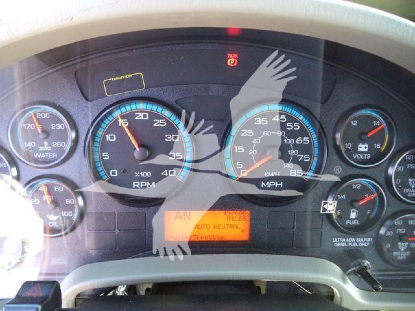 Dashboard of a 2019 International 4300 showing gauges including water temp, RPM, speed, volt, fuel, and an orange message display in center with partially legible words.