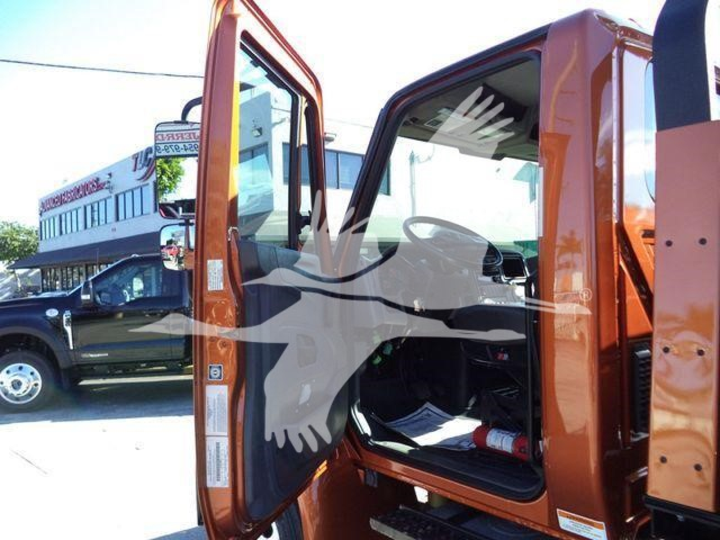 Interior of a 2019 International 4300 rollback truck with open door showing cab interior and seat.