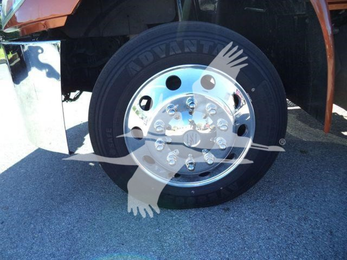 Wheel and front tire of a 2019 International 4300 rollback truck showing alloy hub and tire details.