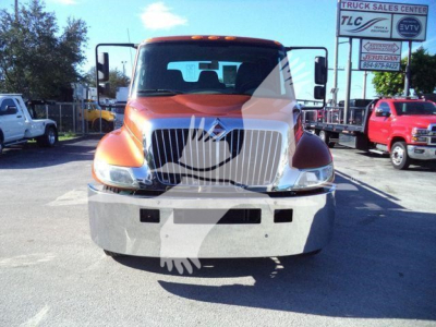 Front view of a 2019 International 4300 rollback truck in orange, showing grille, headlights, and bumper.