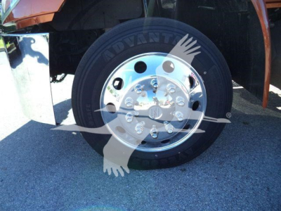 Wheel and front tire of a 2019 International 4300 rollback truck showing alloy hub and tire details.