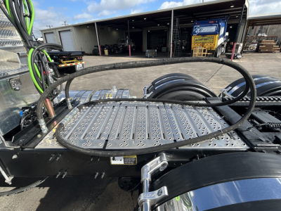 Truck cab area showing mounting plate and hoses on Mack GR84FT chassis with Bobtail area