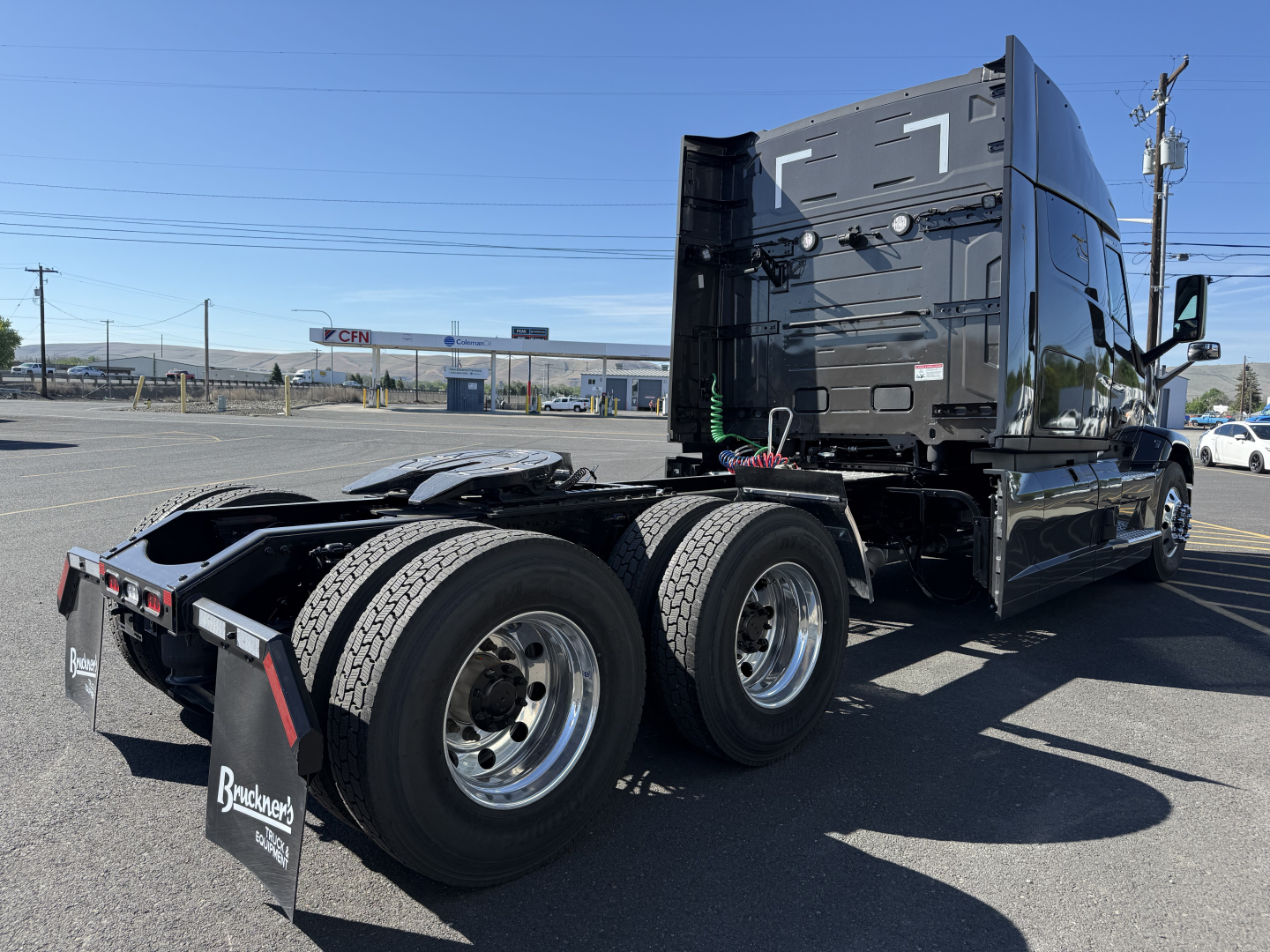 Mack PR64T64M truck tractor rear and side view showing dual rear axles, fifth wheel area, and cab with mirror.