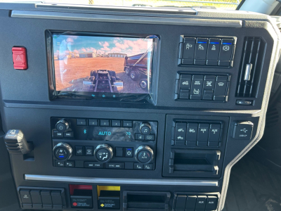 Mack PR64T64M cab interior showing dashboard controls, touch screen, climate controls, and switch panels.