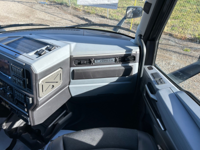 Mack PR64T64M truck interior dashboard view showing Pioneer radio area and glove compartment.