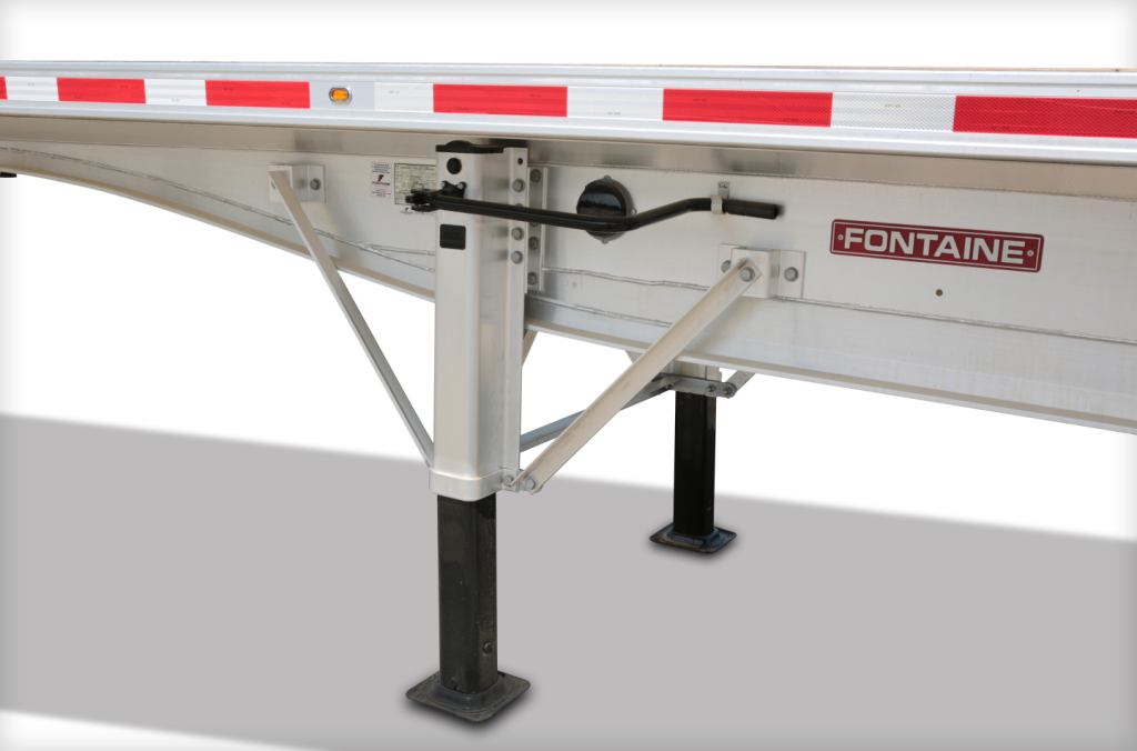 Trailer landing gear and frame of a Fontaine flatbed trailer showing the Fontaine logo and support legs.