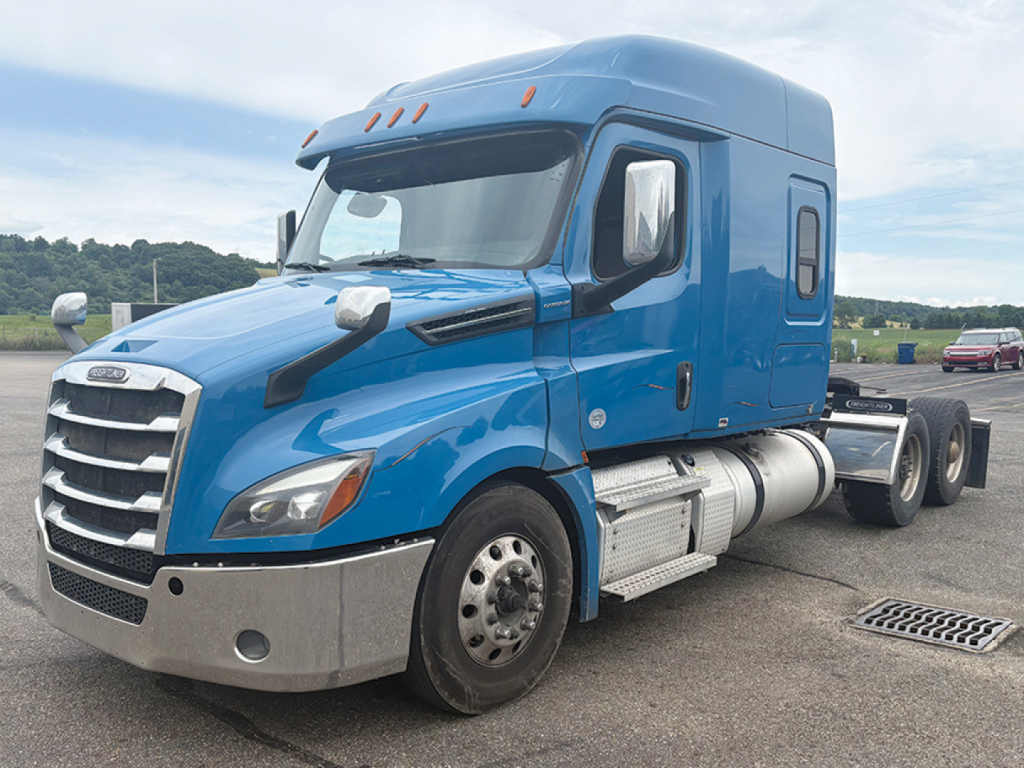 Freightliner Cascadia126 sleeper cab tractor showing side view with blue paint and chrome bumper and fuel tanks.