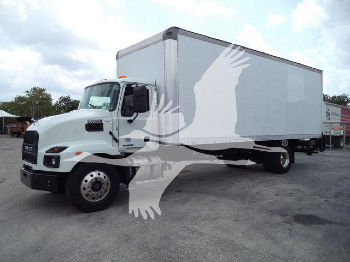 Box truck 2023 Mack MD7 side view showing cab with box trailer attached.